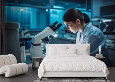 A laboratory technician examines a biological sample under a microscope. Biology and chemistry lab concept. Wall mural