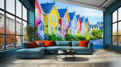 A suburban street lined with colorful townhouses, their facades gleaming in the early morning sun. Wall mural