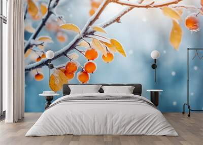 Beautiful branch with orange and yellow leaves in late winter, snowy forest in winter season, snowy weather, december vibes Wall mural