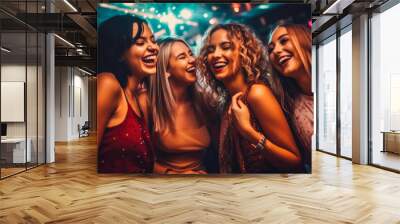 Beautiful young girls dancing in a club, having fun with friends on a night out, night club life. Wall mural