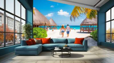 Cancun travel destination. Two tourists walking on beach front view. Tour tourism exploring. Wall mural