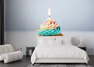 Close up shot of delicious birthday cupcake on light background, celebration muffin with candle ready to be blown, concept of celebration Wall mural