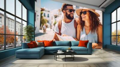 Couple mixed race traveling in summer time in greek city looking at the map. Honeymoon trip, backpacker tourist, tourism or holiday vacation travel concept. Wall mural