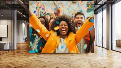 Happy diverse business team celebrating success and having fun all together with confetti falling around them. Wall mural