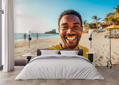 Happy young african american man enjoying a day on the beach while smiling and making a picture Wall mural