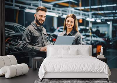 Male and female mechanics working together in large modern garage. Two car mechanic working in garage, young woman learning mechanical skills Wall mural