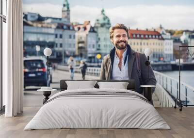 Man traveling in Oslo in autumn. Happy young traveler exploring in City. Wall mural