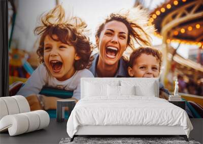 Mother and two children riding a roller coaster together having fun. Happy family on a fun roller coaster ride in an amusement park. Laughing. Wall mural