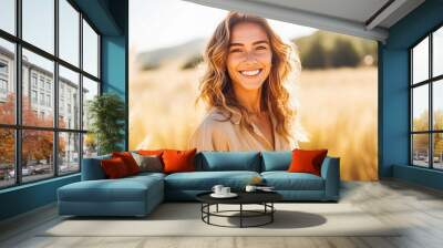 Portrait of beautiful young caucasian woman smiling while standing in field of wheat, natural light Wall mural