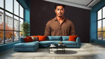 Portrait of handsome indian male looking serious in casual clothes on a colored background Wall mural