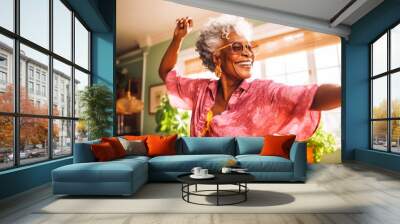 Positive black older woman dancing at home. Happiness and well being concept. Wall mural