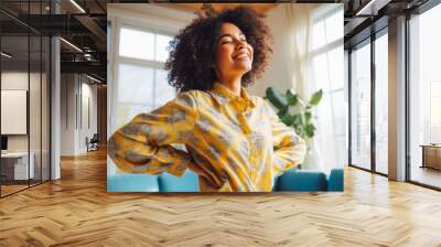 Positive black woman dancing at home. Happiness and well being concept. Wall mural