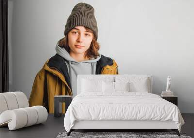 Teenager holding smartphone on white studio background Wall mural