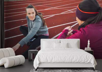 Women Stretching on a Running Track at Sunset Wall mural