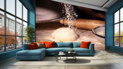 Male hands holding piece of dough. Preparing bread dough in a bakery close up Wall mural