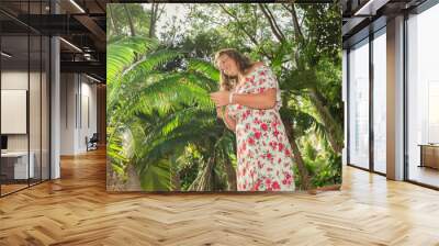 holguin province, cuba,dec.23,2019, beautiful young girl wondering in tropical garden on sunny gorge Wall mural