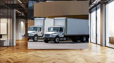 Small compact rigs semi trucks with long box trailers standing in warehouse dock loading cargo for delivery Wall mural