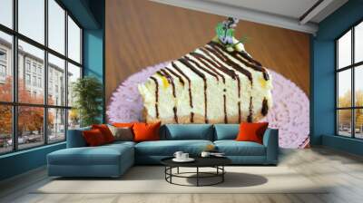 A piece of cheesecake on a pink plate, a delicious and healthy dessert. Wall mural