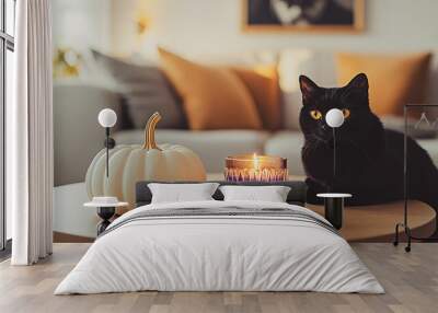 Modern interior of a room decorated for Halloween. Black cat with yellow eyes. White pumpkin, a candle on a round table. October 31 decor. Fall season Wall mural