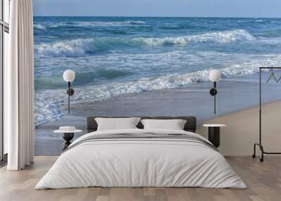 Sea, Blue waves with white foam, under the blue sky. Wall mural