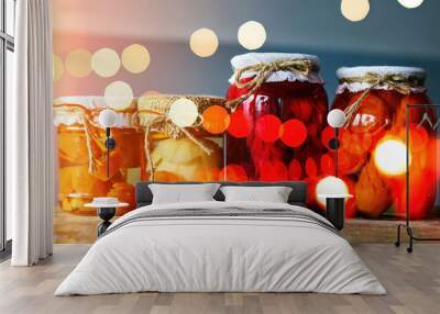 Colorful homemade preserves glimmering under soft lights on a rustic wooden table in a cozy kitchen during the afternoon Wall mural