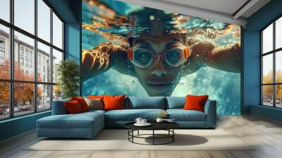 A woman is seen wearing goggles as she swims in the water. Wall mural