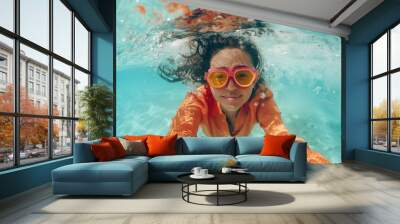 a woman wearing goggles gracefully swims in a shimmering pool, embracing the waters cool embrace as  Wall mural