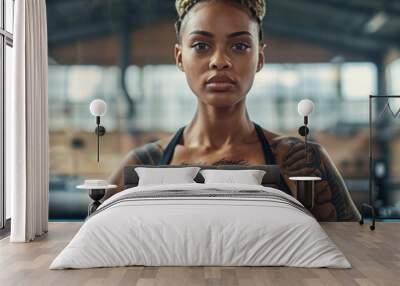 young woman stands confidently in a boxing ring, her gaze fixed on the camera, showcasing her strength and determination. Wall mural