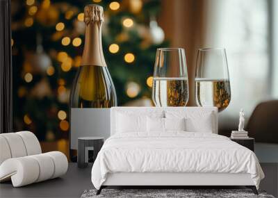 Close-up of sparkling wine bottle with blank white template lable, with two glasses of sparkling wine on a Christmas table Wall mural