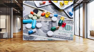 Different colorful pills capsules on money bills. Concept of expensive treatment, medicine, medical insurance. Wall mural