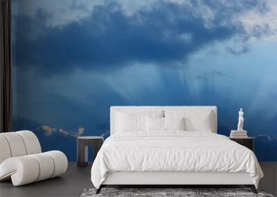 Sky and clouds. Storm cloud with a luminous edge and rays of the sun. Wall mural