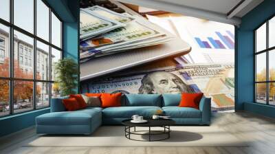 Cash on a laptop and financial documents. Investment management. Money. Wall mural