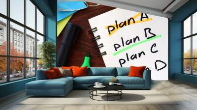 Cross plan A, underline plan B concept  written in a notebook on a wooden table. Wall mural