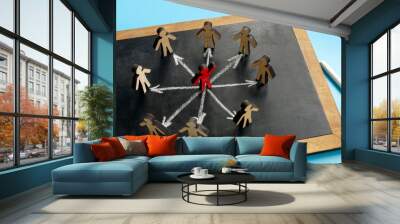 Figurine in the center of others. Brand ambassador concept. Wall mural