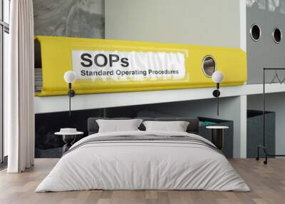 SOP Standard operating procedure concept. A yellow folder lies on an office shelf. Wall mural