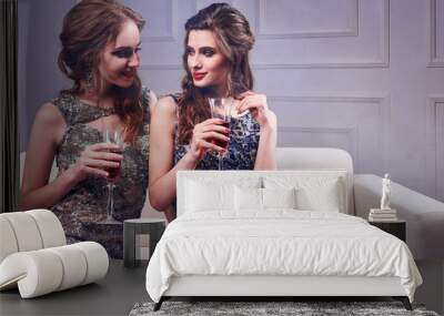 portrait of two elegant young women with a champagne glasses at celebration Wall mural