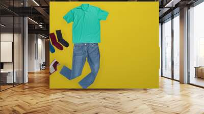 flat lay, men's fashion. jeans, t-shirt, socks on a wooden background. casual clothes top view Wall mural