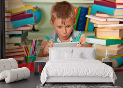 Boy studying in the library. Wall mural