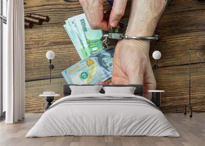 removing handcuffs from hands on a money banknotes background. Wall mural