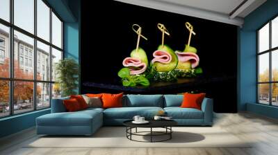 canapes bacon cucumber on black background with reflection Wall mural