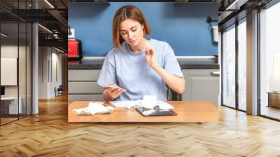 Close up of shocked woman sitting at the table, stressed and confused by calculate expense from invoice or bills, have no money to pay mortgage or loan. High prices and spending money concept Wall mural