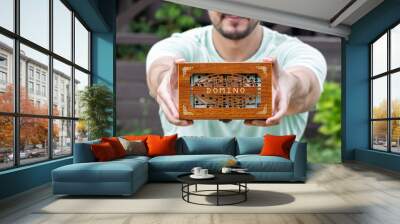 Close-up shot of a man playing dominoes in the yard on a beautiful summer day	 Wall mural