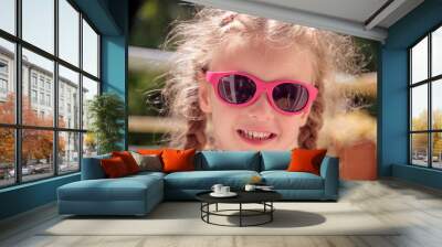 little Caucasian girl with sunglasses Wall mural