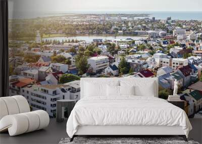 Panoramic view from above on cozy city neighborhood with green trees, pond and sea harbour in clear sunny summer day. Reykjavik, Iceland Wall mural