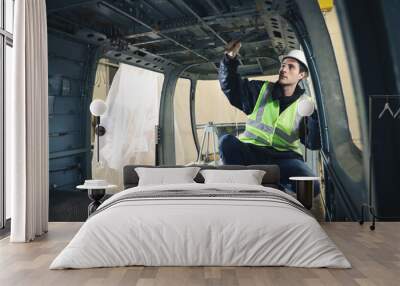 Portrait of a Caucasian man , factory engineer in work clothes controlling the work process at the helicopter manufacturer. Wall mural