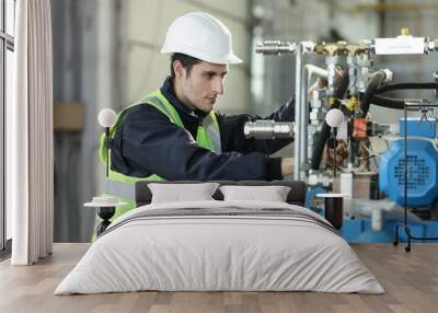 Portrait of a man , factory engineer in work clothes controlling the work process at the airplane manufacturer.	 Wall mural