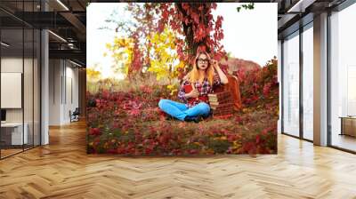 girl with glasses with books in nature autumn Wall mural