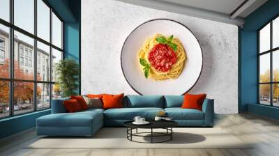 top view spaghetti pasta in tomato sauce, parmesan cheese and basil on white plate on light backgrou Wall mural