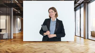 Young attractive and smiling business woman in black suit holding gadget isolated on white. Copy space and place for text concept Wall mural