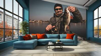 Fishing background. Happy angler with perch fishing trophy. Wall mural